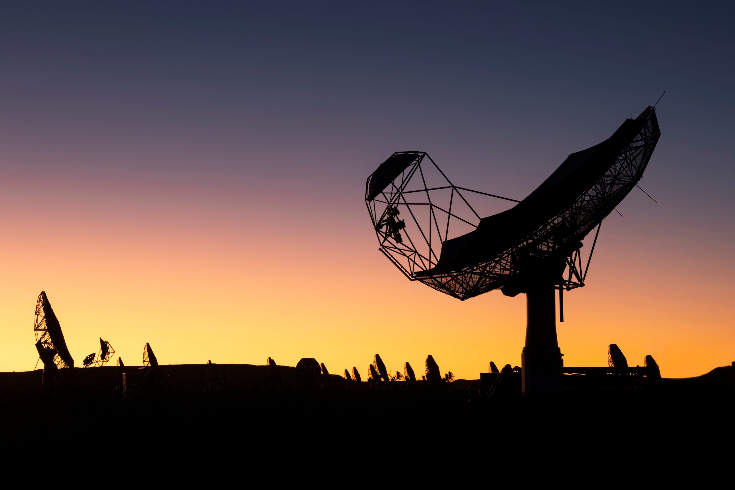 A photo of the SKA-Mid telescope in South Africa during sunset.
